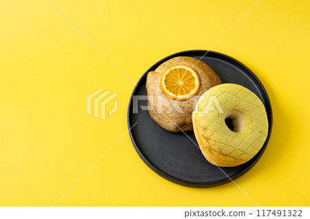 Donuts on a yellow background 117491322