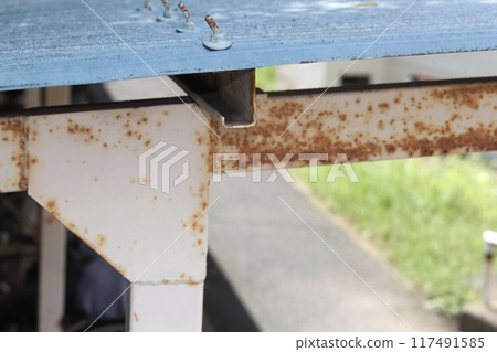 Rusty bicycle parking lot roof 117491585