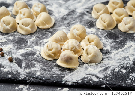 Handmade Ukrainian meat dumplings, ready for cooking, traditional varenyky with meat filling Handmade Ukrainian meat dumplings, ready for cooking, traditional varenyky with meat filling 117492517