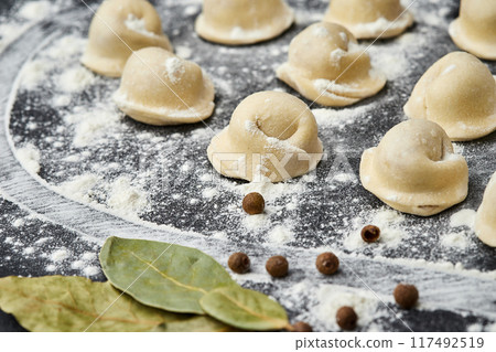 Homemade meat dumplings ready for cooking, a classic dish perfect for hearty family meals 117492519
