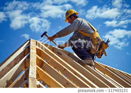 Builders assembling roof trusses 117493231