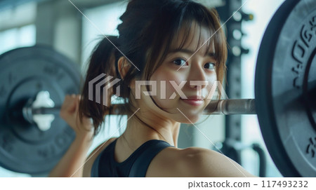 Woman training in a fitness gym Woman training in a fitness gym 117493232