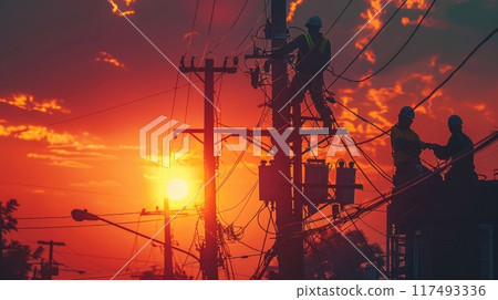 Workers on power lines during a fiery sunset 117493336