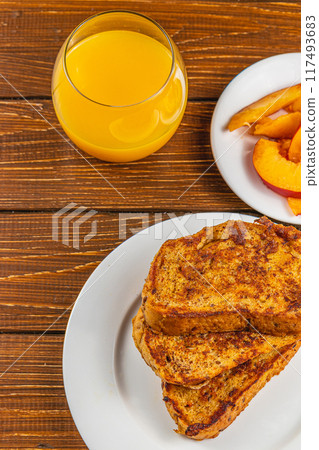 French toast on a plate with blueberries, orange juice, nectarine for breakfast French toast on a plate with blueberries, orange juice, nectarine for breakfast 117493683