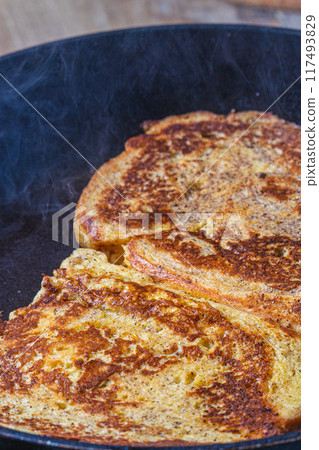 Cooking french toast in a pan on butter 117493829
