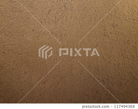 A horizontal background image of a light brown clay wall with a surface that has the texture of straw remaining 117494368