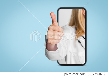 A doctors hand emerges from a smartphone screen, giving a thumbs up gesture. This image is a representation of modern healthcare and the use of technology for communication and patient care. A doctors hand emerges from a smartphone screen, giving a thumbs up gesture. This image is a representation of modern healthcare and the use of technology for communication and patient care. 117494662