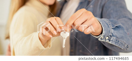 Couple Holding Keys Of Their New House, Crop, Panorama Couple Holding Keys Of Their New House, Crop, Panorama 117494685