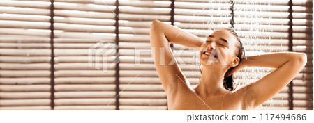 Morning routine. Woman in the shower, standing under refreshing water, panorama 117494686
