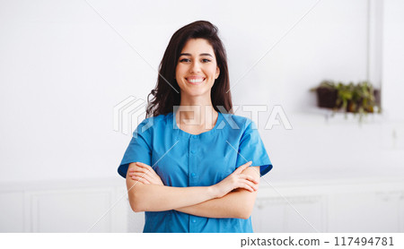 Happy Intern Posing To Camera During Conference. Doctors Discussing On Background 117494781