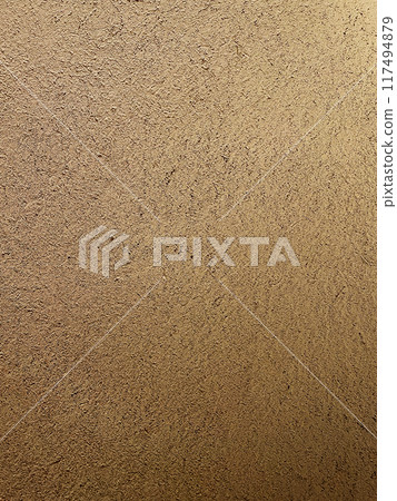 A vertically long background image of a light brown clay wall with a surface that has the texture of straw remaining 117494879
