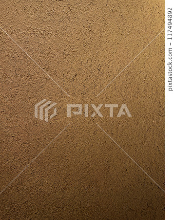A vertical background image of a brown clay wall with a surface that has the texture of straw remaining 117494892
