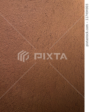 A vertically long background image of a reddish-brown clay wall with a surface that has the texture of straw remaining 117494903