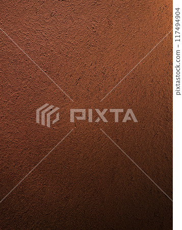 A vertical background image of a dark reddish brown earthen wall with a straw-like surface 117494904