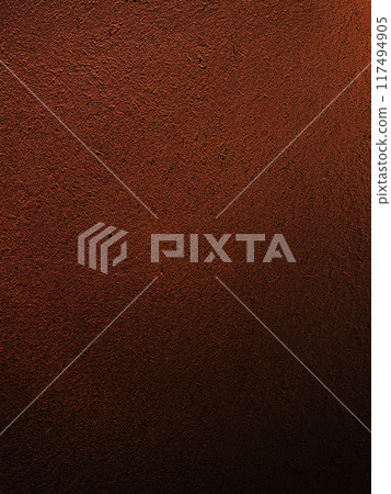 A vertically long background image of a surface that has the texture of straw remaining in a deep, dark reddish brown earthen wall 117494905