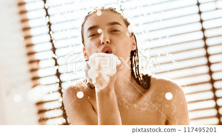 Woman Blowing Foam And Having Fun In Shower, Closeup Woman Blowing Foam And Having Fun In Shower, Closeup 117495201