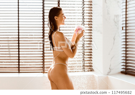 Slim Woman Washing In Bathroom Under Shower Jet, Wearing Bra And Bikini 117495682