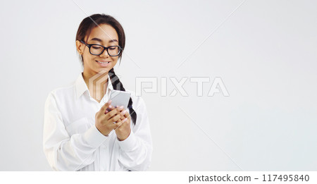 Interested student girl texting on smartphone on grey background, crop 117495840