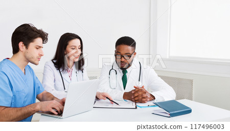 Medical Education. Interns Meeting With Mentor And Taking Notes At Hospital Medical Education. Interns Meeting With Mentor And Taking Notes At Hospital 117496003