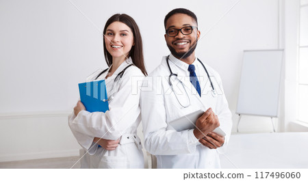 Diverse Professional Doctors In White Coats Posing To Camera At Conference Room 117496060