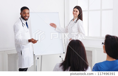 Sharing Experience. Doctors Giving Lecture To Interns At Medical Seminar In Hospital 117496391