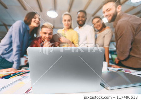 IT designers brainstorming, discussing new ideas on laptop in modern coworking space IT designers brainstorming, discussing new ideas on laptop in modern coworking space 117496618