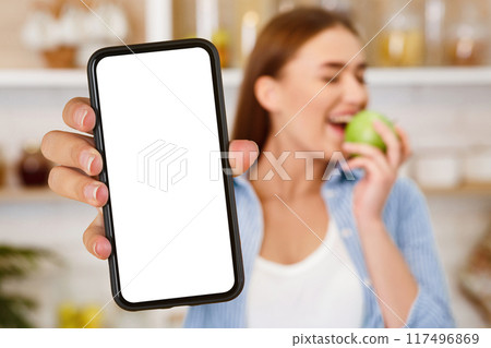 Healthy Eating. Girl Rejecting Junk Food, Choosing Fresh Apple, Focus on Donut Healthy Eating. Girl Rejecting Junk Food, Choosing Fresh Apple, Focus on Donut 117496869