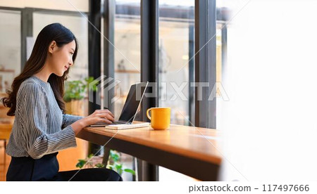 Female college student studying in a cafe Female college student studying in a cafe 117497666