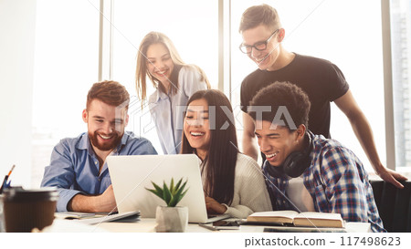 Exams preparation. Multiracial students preparing for exams in library, using laptop together 117498623