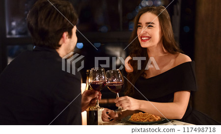Sweet couple having romantic dinner in restaurant. Happy lovers celebrating anniversary together concept Sweet couple having romantic dinner in restaurant. Happy lovers celebrating anniversary together concept 117498718