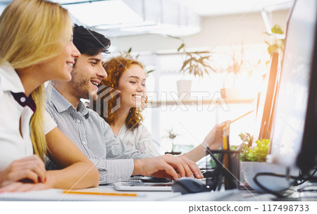Young creative team discussing new marketing strategy, sitting together in office, empty space Young creative team discussing new marketing strategy, sitting together in office, empty space 117498733