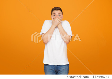 Funny men covering his mouth, ears and eyes over orange background 117498787