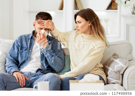 Woman Taking Care Of Her Ill Husband, Touching His Forehead 117498956