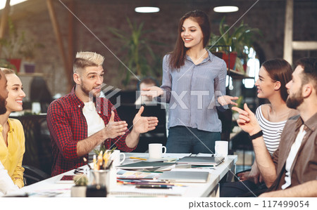 Work discussion. Designers working on new project, sitting together in modern office Work discussion. Designers working on new project, sitting together in modern office 117499054