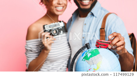 Go on bus tour. Happy couple preparing for journey, choosing route on pink background Go on bus tour. Happy couple preparing for journey, choosing route on pink background 117499129