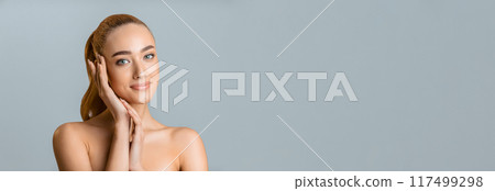 Skin care concept. Beautiful woman touching face with perfect fresh skin, grey background 117499298