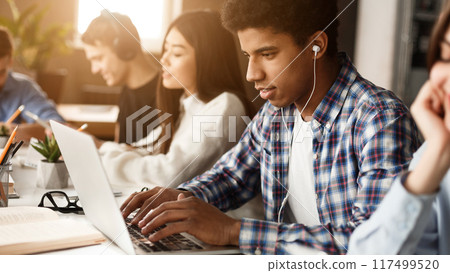 Student learning lessons in school library, making research on laptop and browse internet Student learning lessons in school library, making research on laptop and browse internet 117499520