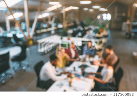 Corporate employees working at coworking place, discussing project at workplace, blurred photo 117500098