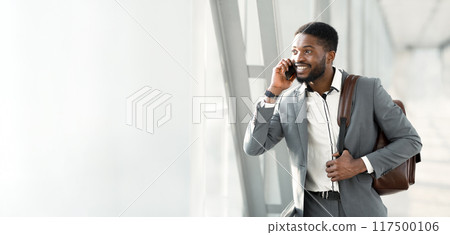 Business Talk. Businessman Calling On Phone, Arriving at Airport, Free Space Business Talk. Businessman Calling On Phone, Arriving at Airport, Free Space 117500106