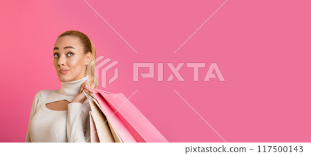 Black friday. Thoughtful girl with shopping bags posing over pink background, free space 117500143