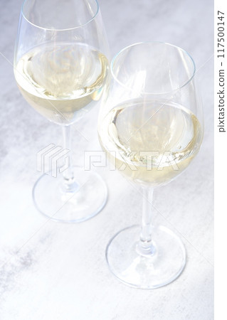 Image of a toast with two wine glasses filled with white wine Image of a toast with two wine glasses filled with white wine 117500147