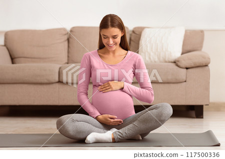 Happy Pregnant Woman Touching Belly, Smiling And Thinking About The Baby 117500336