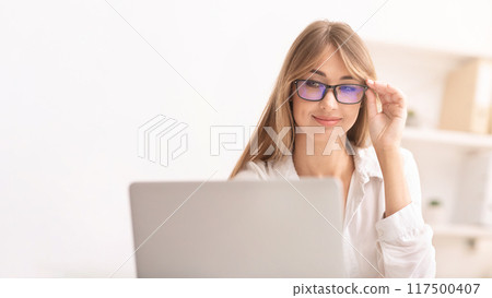Computer Eyeglasses. Woman Using Laptop In Eyewear Working In Modern Office. Selective Focus 117500407