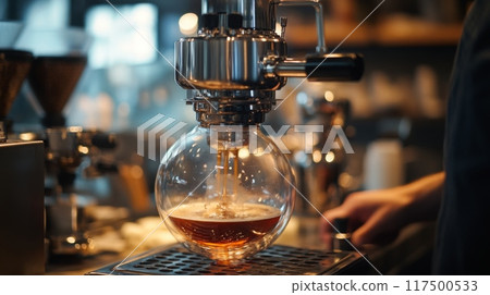 A barista skillfully brews coffee with a vacuum siphon, showcasing the technique in a vibrant cafe atmosphere. 117500533