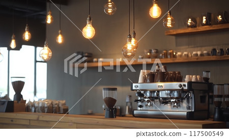 Warm lighting enhances the cozy atmosphere of a coffee shop featuring an espresso machine and wooden shelves. 117500549