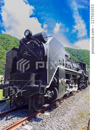 Steam locomotive against a blue sky 117501053