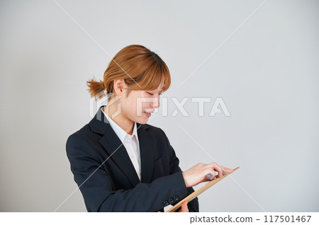 Business woman taking survey sales binder memo Business woman taking survey sales binder memo 117501467