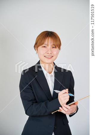 Business woman taking survey sales binder memo Business woman taking survey sales binder memo 117501519