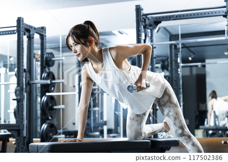 Young woman training in a sports gym 117502386