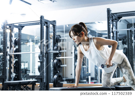 Young woman training in a sports gym Young woman training in a sports gym 117502389